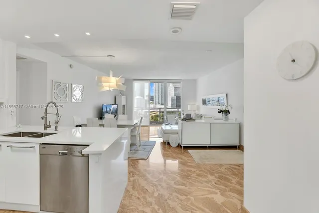 a living room with kitchen island furniture and a kitchen view