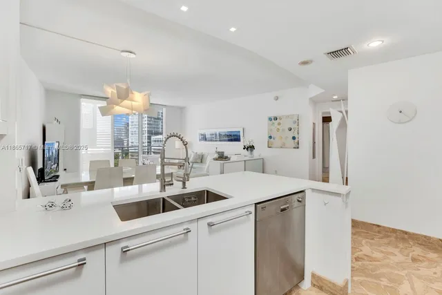 a kitchen with stainless steel appliances a sink and a refrigerator