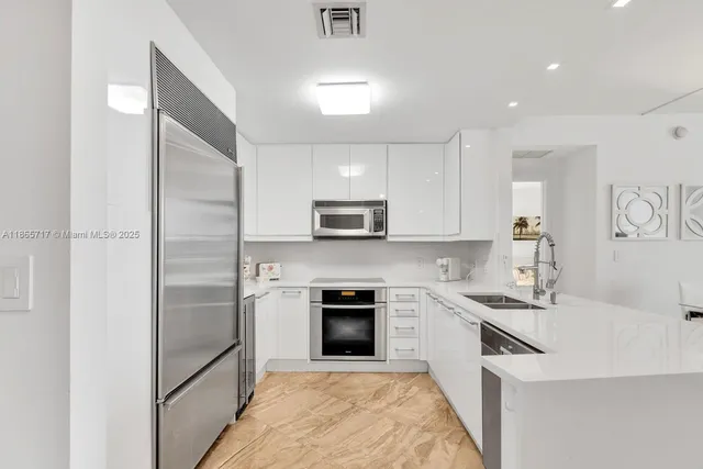 a kitchen with a sink stainless steel appliances and cabinets