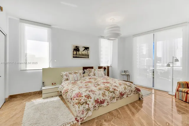 a bedroom with a bed and a table in it with window