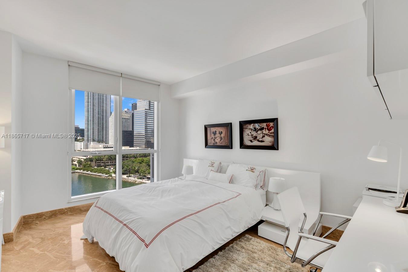 901 Brickell Key Boulevard, Unit 1409 Miami, FL 33131 - Photo 21 of 39 a bedroom with a bed and a large window