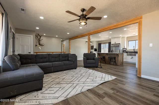 a kitchen with stainless steel appliances kitchen island granite countertop a stove a sink and a microwave