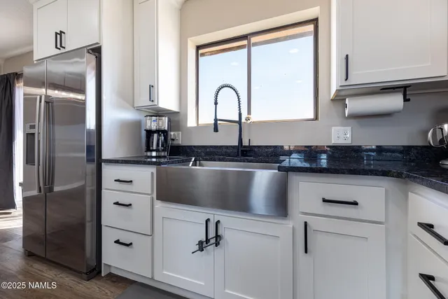 a bathroom with a granite countertop sink toilet a mirror and shower
