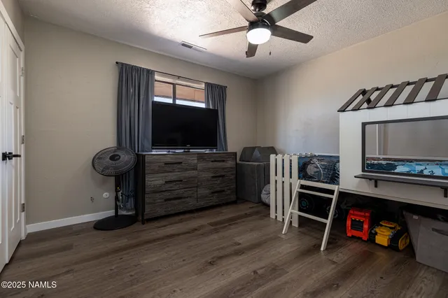 a view of a livingroom with furniture and a ceiling fan