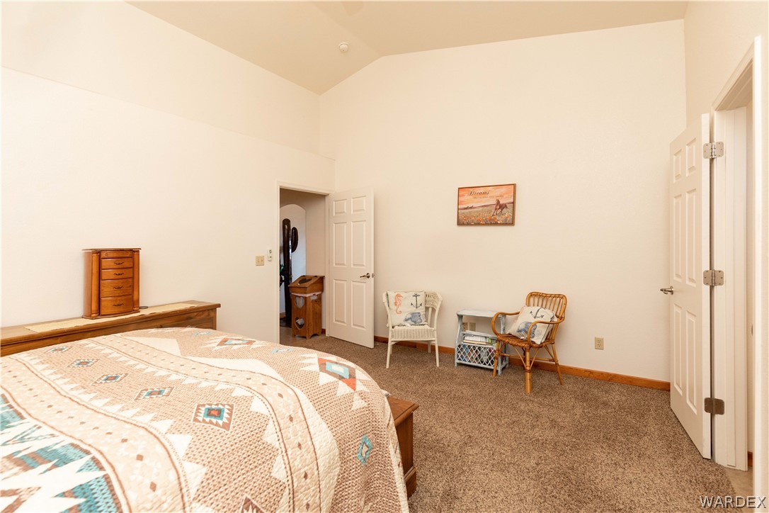300 South Cibola Road Golden Valley, AZ 86413 - Photo 18 of 67 a bedroom with a bed and a chair