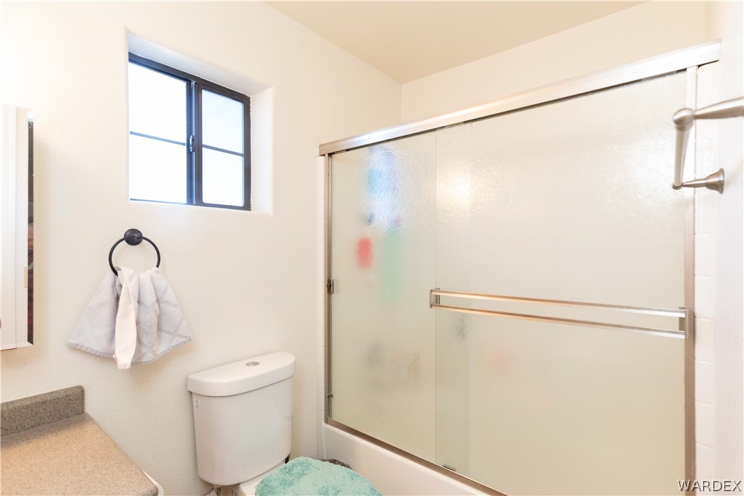 300 South Cibola Road Golden Valley, AZ 86413 - Photo 27 of 67 a bathroom with a shower a toilet and a sink