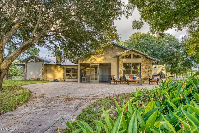 a front view of a house with yard and green space
