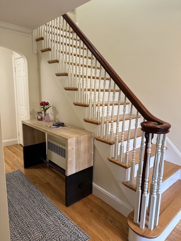 45 Wellesley Road Belmont, MA 02478 - Photo 18 of 42 a living room with wooden floor and stairs