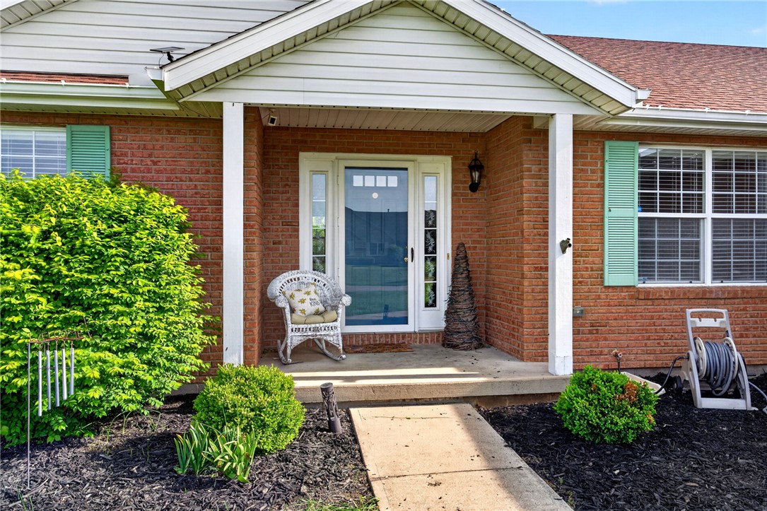 4996 Shannon Avenue Springfield, OH 45504 - Photo 12 of 61 Welcome to this inviting residence, featuring classic brick construction and a welcoming covered porch.