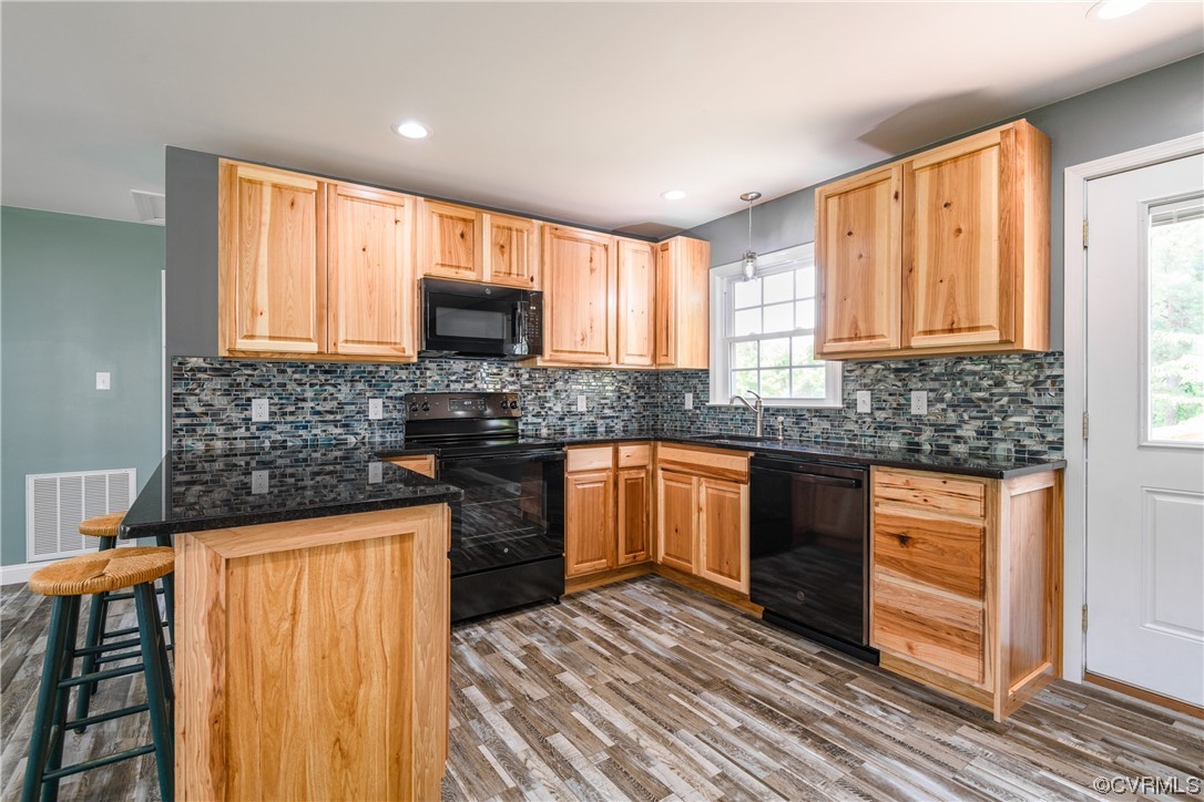 338 Prospect Road Prospect, VA 23960 - Photo 14 of 41 a kitchen with granite countertop wooden cabinets a stove top oven and stainless steel appliances