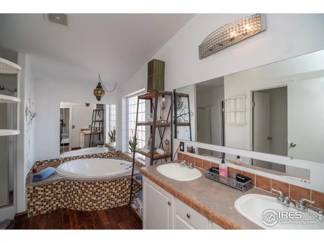 a bedroom with a bed and a dresser with mirror