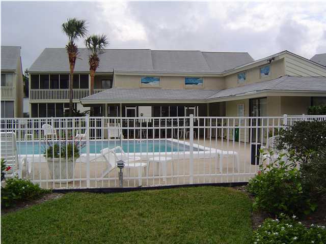 71 Misty Cove, Unit 207 Destin, FL 32550 - Photo 3 of 9 a front view of a house with a garden and deck