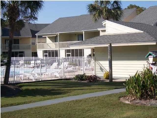 71 Misty Cove, Unit 207 Destin, FL 32550 - Photo 5 of 9 a front view of a house with a yard