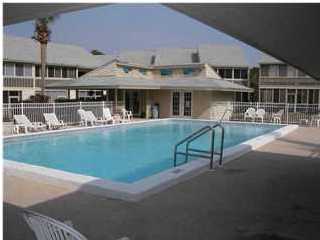 71 Misty Cove, Unit 207 Destin, FL 32550 - Photo 6 of 9 a front view of a house with swimming pool having outdoor seating