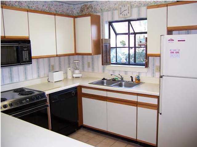 71 Misty Cove, Unit 207 Destin, FL 32550 - Photo 7 of 9 a kitchen with a sink stove and microwave