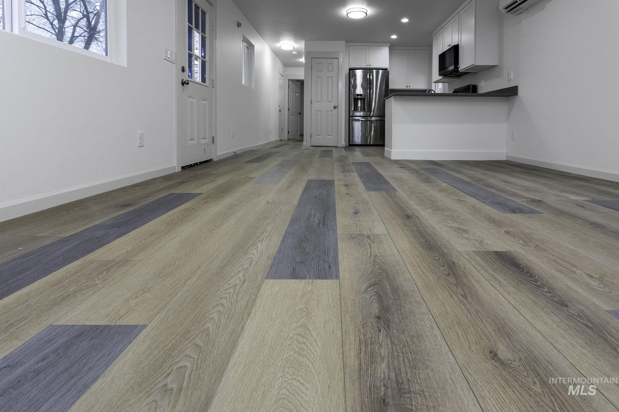 450 Greenleaf Street Boise, ID 83713 - Photo 12 of 17 Unfurnished living room with light wood-type flooring, recessed lighting, and a wall mounted AC