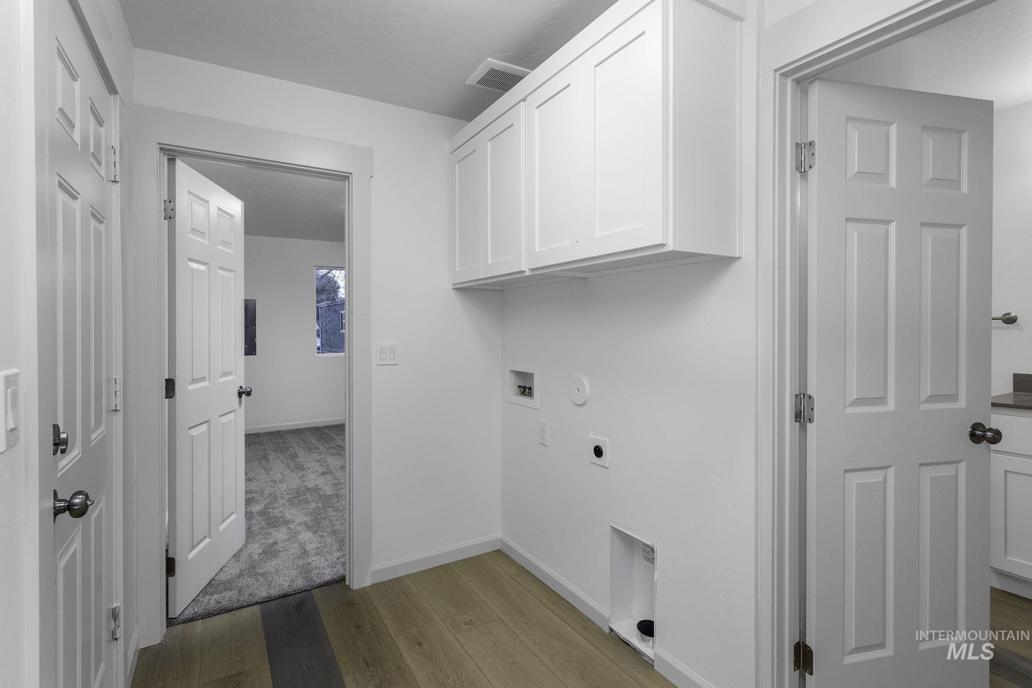 450 Greenleaf Street Boise, ID 83713 - Photo 13 of 17 Laundry room with light wood-style flooring, cabinet space, washer hookup, hookup for an electric dryer, and gas dryer hookup