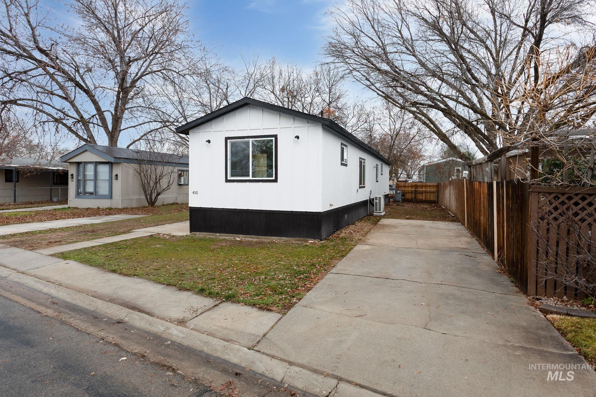 450 Greenleaf Street Boise, ID 83713 - Photo 2 of 17 View of side of home featuring an ac unit and board and batten siding