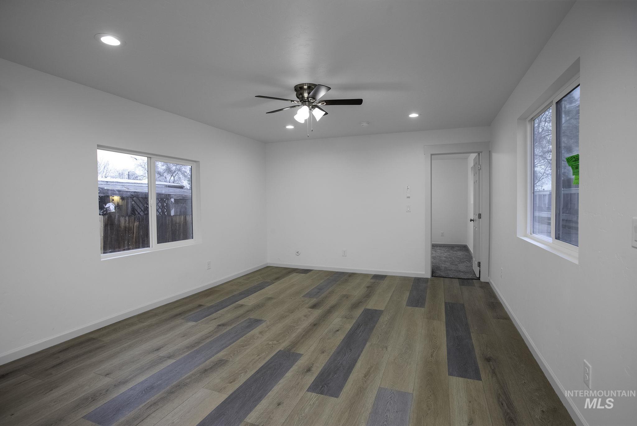 450 Greenleaf Street Boise, ID 83713 - Photo 6 of 17 Empty room with recessed lighting, wood finished floors, ceiling fan, and healthy amount of natural light