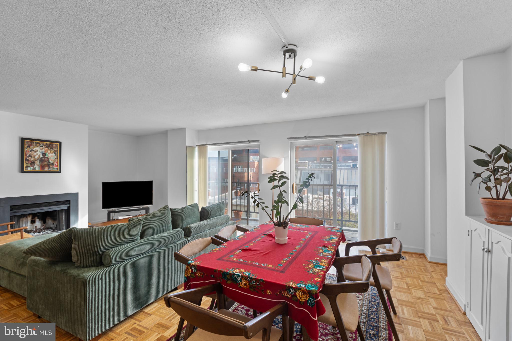 3210 Grace Street Northwest, Unit 309 Washington, DC 20007 - Photo 11 of 43 a living room with furniture a flat screen tv and a fireplace