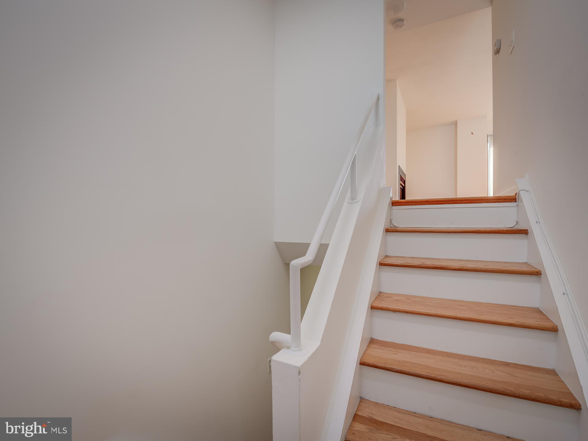 3210 Grace Street Northwest, Unit 309 Washington, DC 20007 - Photo 19 of 43 a view of staircase with white walls and white door