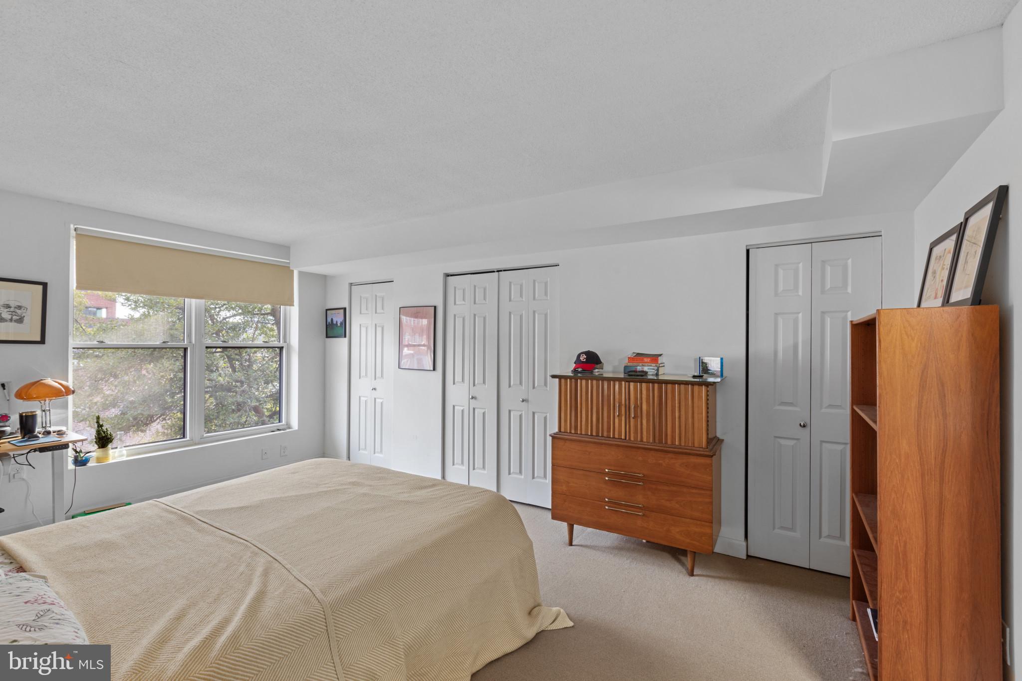 3210 Grace Street Northwest, Unit 309 Washington, DC 20007 - Photo 20 of 43 a bedroom with a bed and a large window