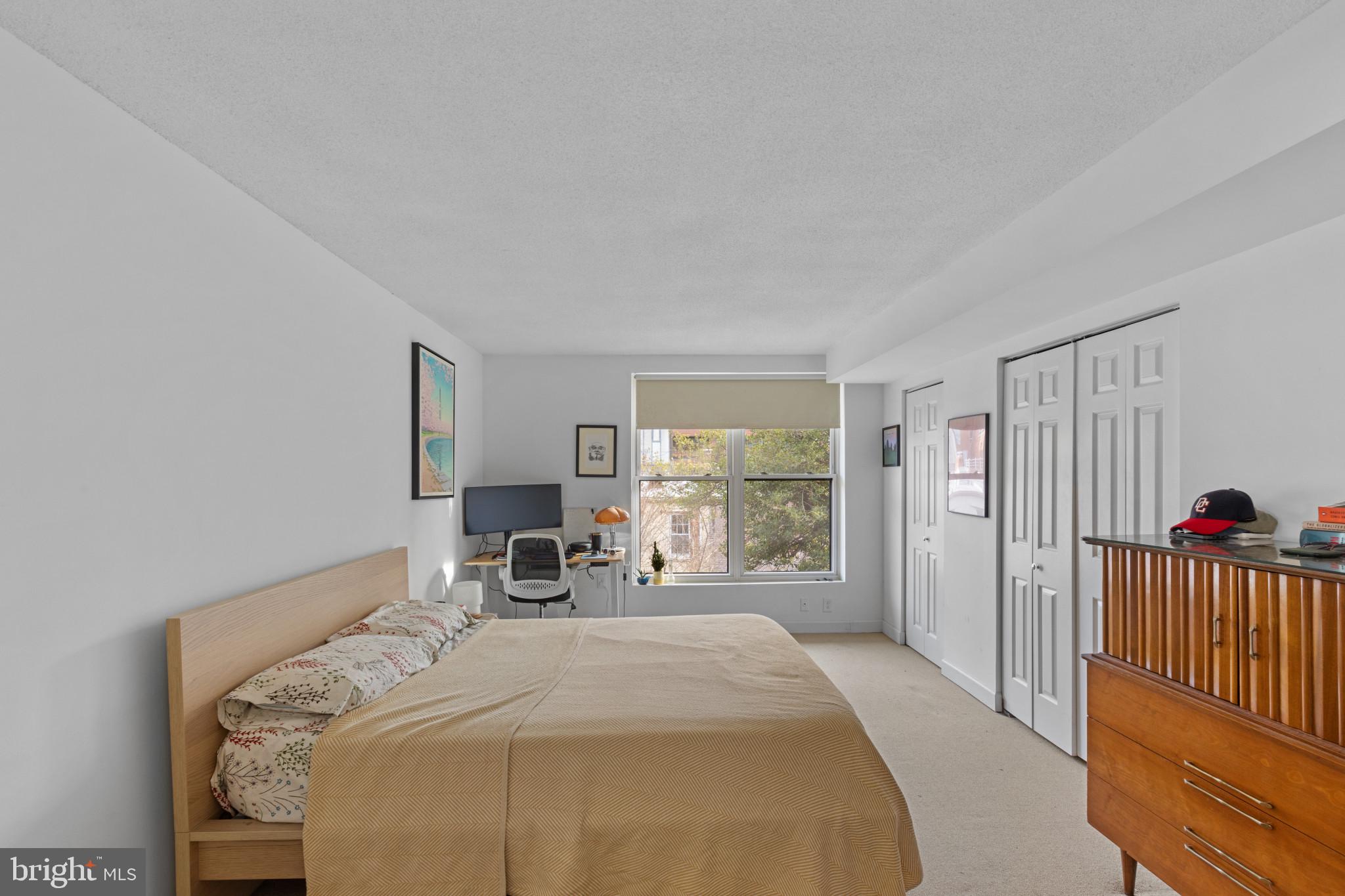 3210 Grace Street Northwest, Unit 309 Washington, DC 20007 - Photo 22 of 43 a bed sitting in a bedroom next to a window
