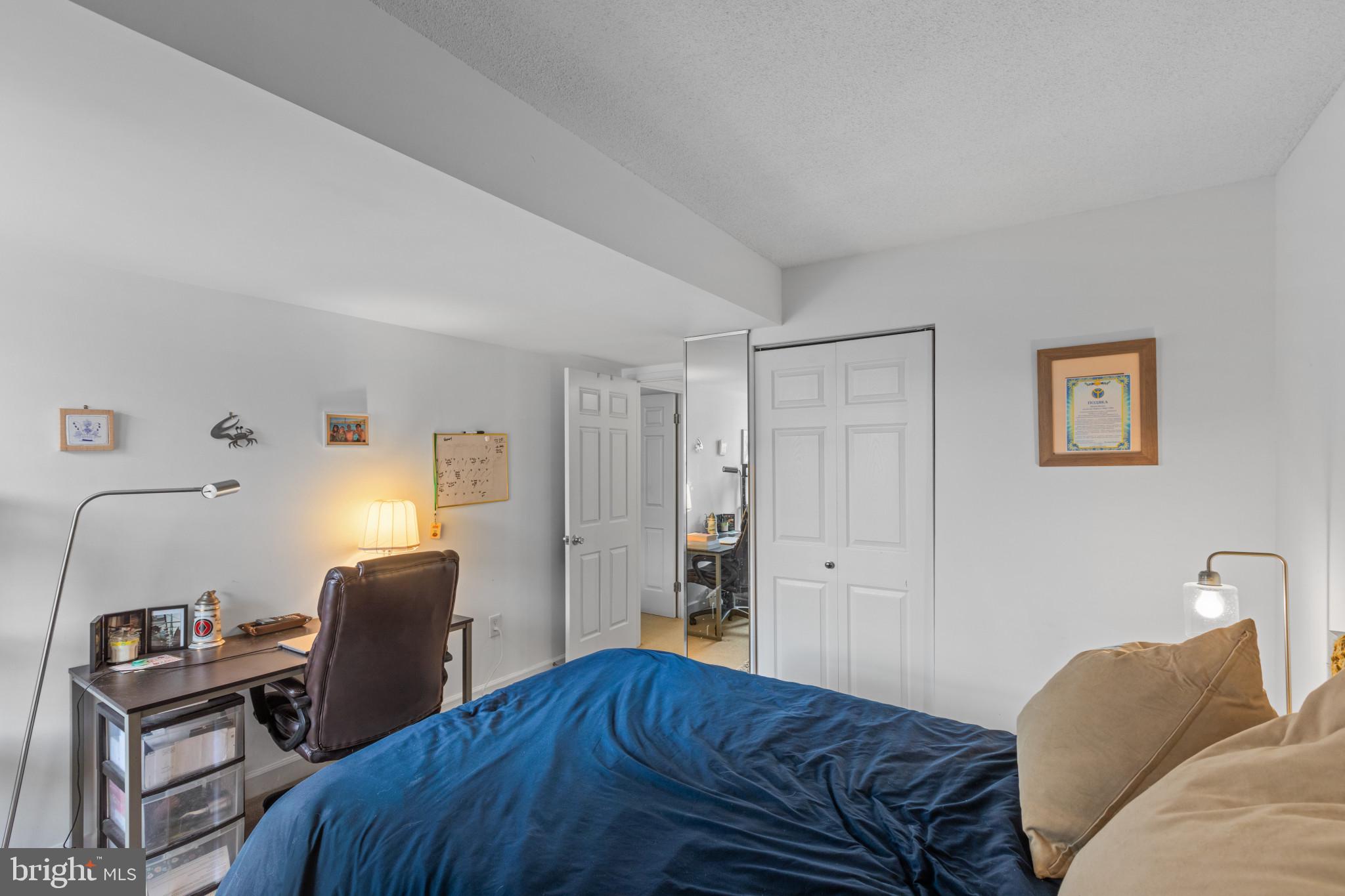 3210 Grace Street Northwest, Unit 309 Washington, DC 20007 - Photo 29 of 43 a bedroom with a bed and a chair