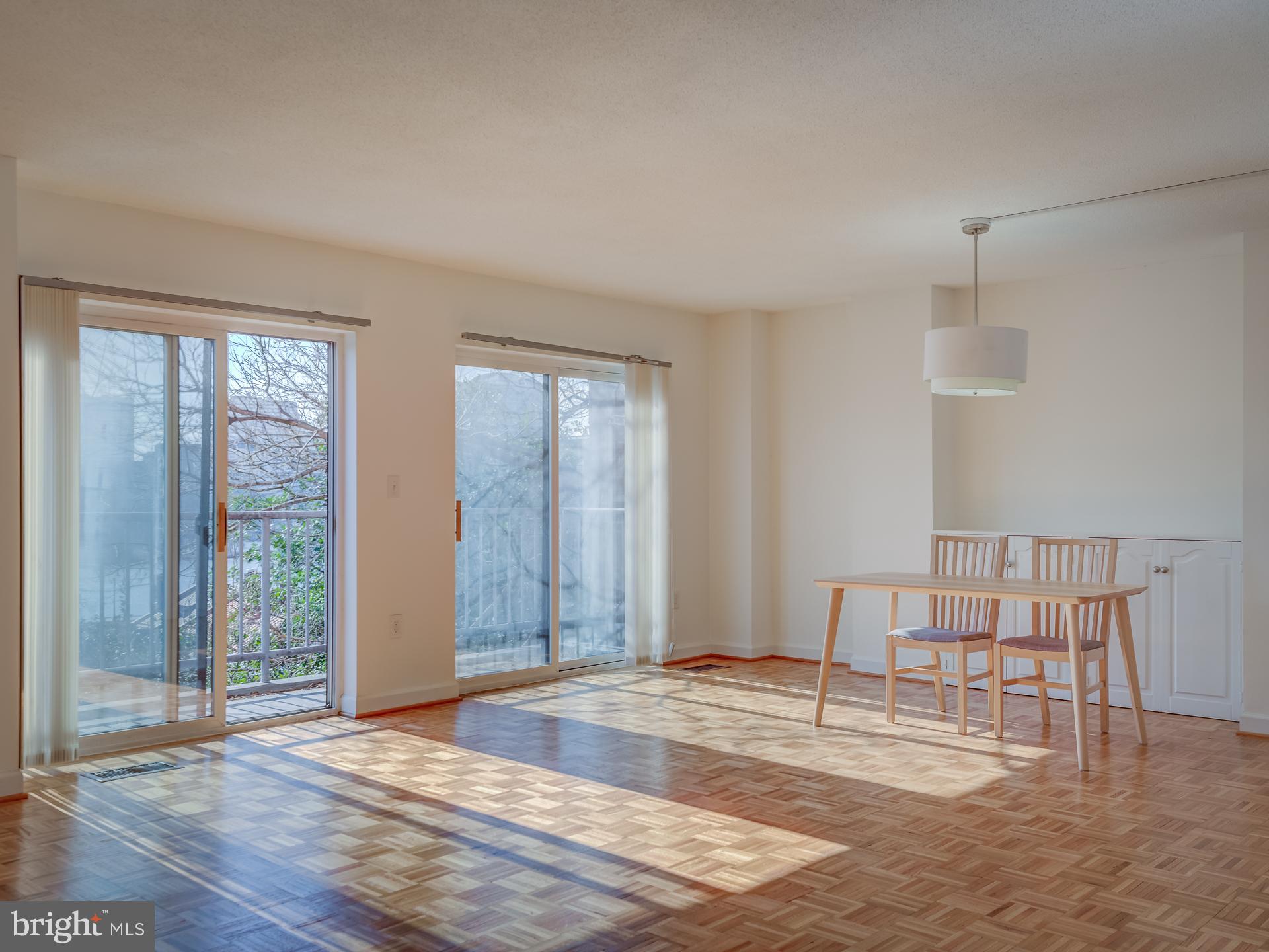 3210 Grace Street Northwest, Unit 309 Washington, DC 20007 - Photo 6 of 43 a view of empty room with wooden floor and fan