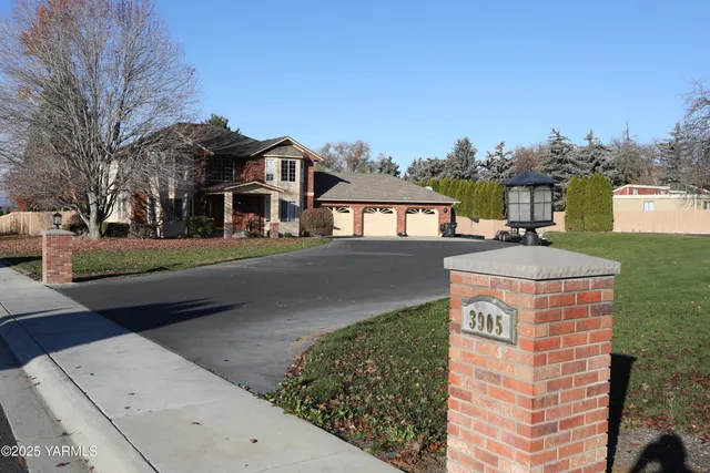 a front view of a residential apartment building with a yard