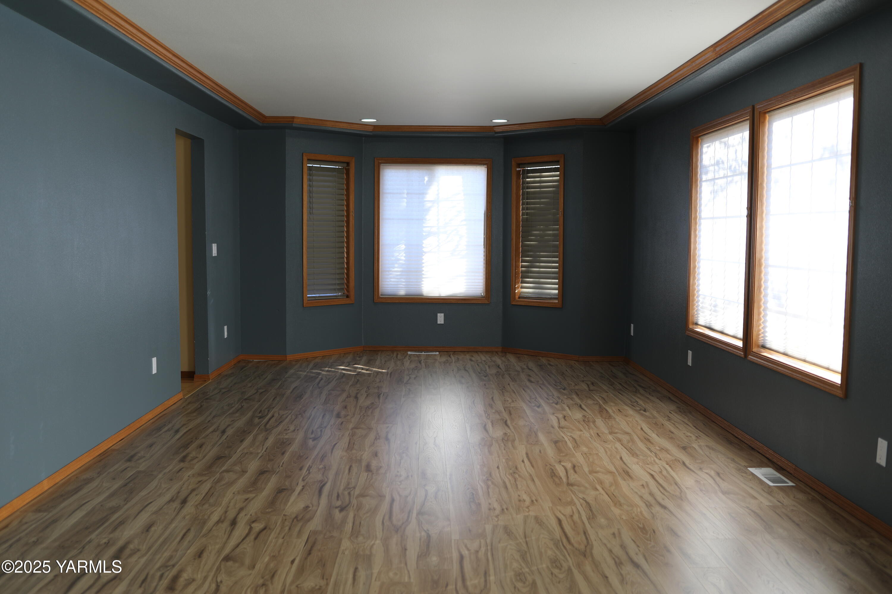 3905 Isabella Way Yakima, WA 98901 - Photo 7 of 10 a view of an empty room with wooden floor and a window