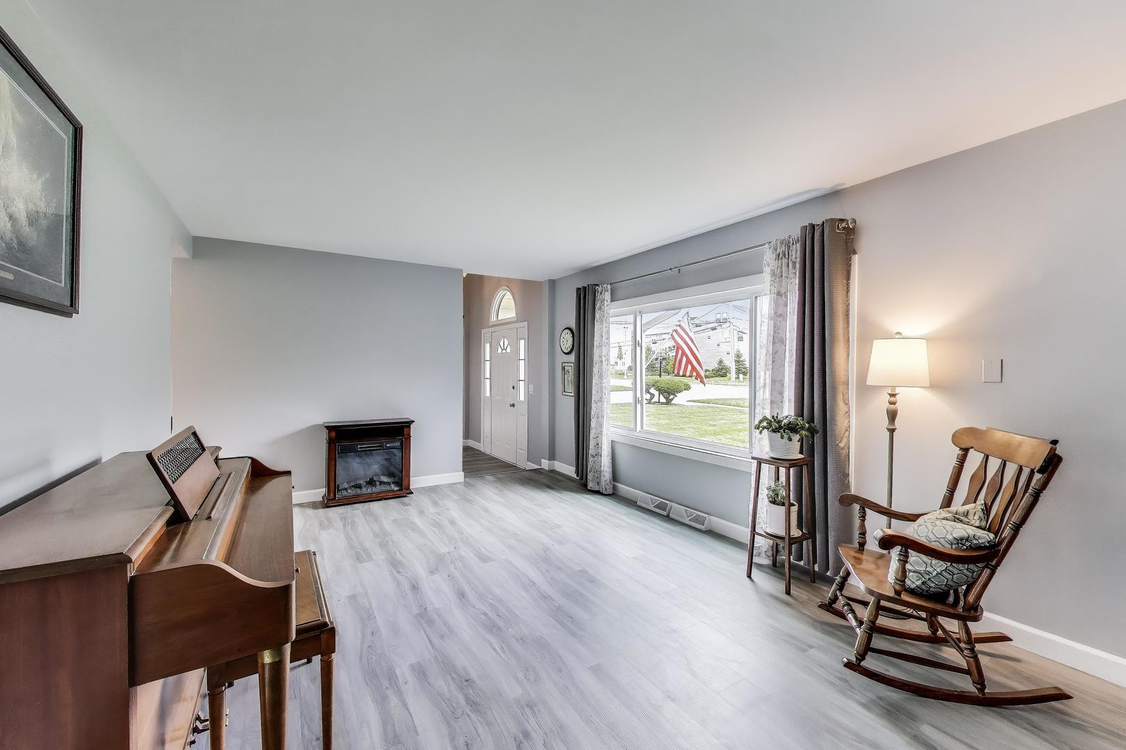3205 Meadow Drive Rolling Meadows, IL 60008 - Photo 4 of 35 a living room with furniture and a fireplace