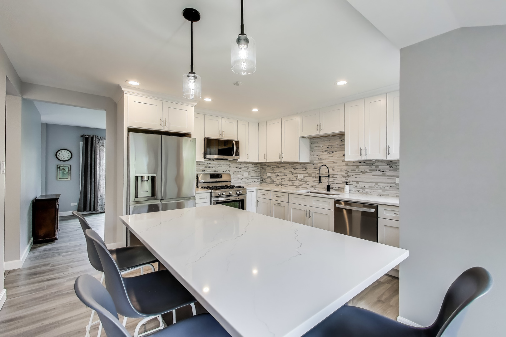 3205 Meadow Drive Rolling Meadows, IL 60008 - Photo 8 of 35 a kitchen with kitchen island a stove a table and chairs