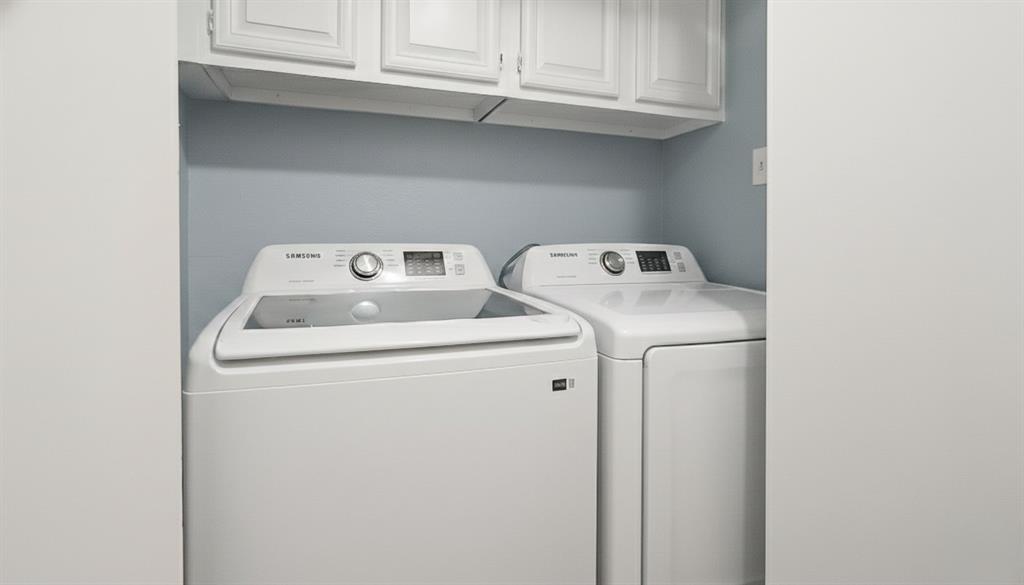 12921 Abrams Road, Unit 505 Dallas, TX 75243 - Photo 14 of 24 Laundry area with washer and dryer and cabinet space