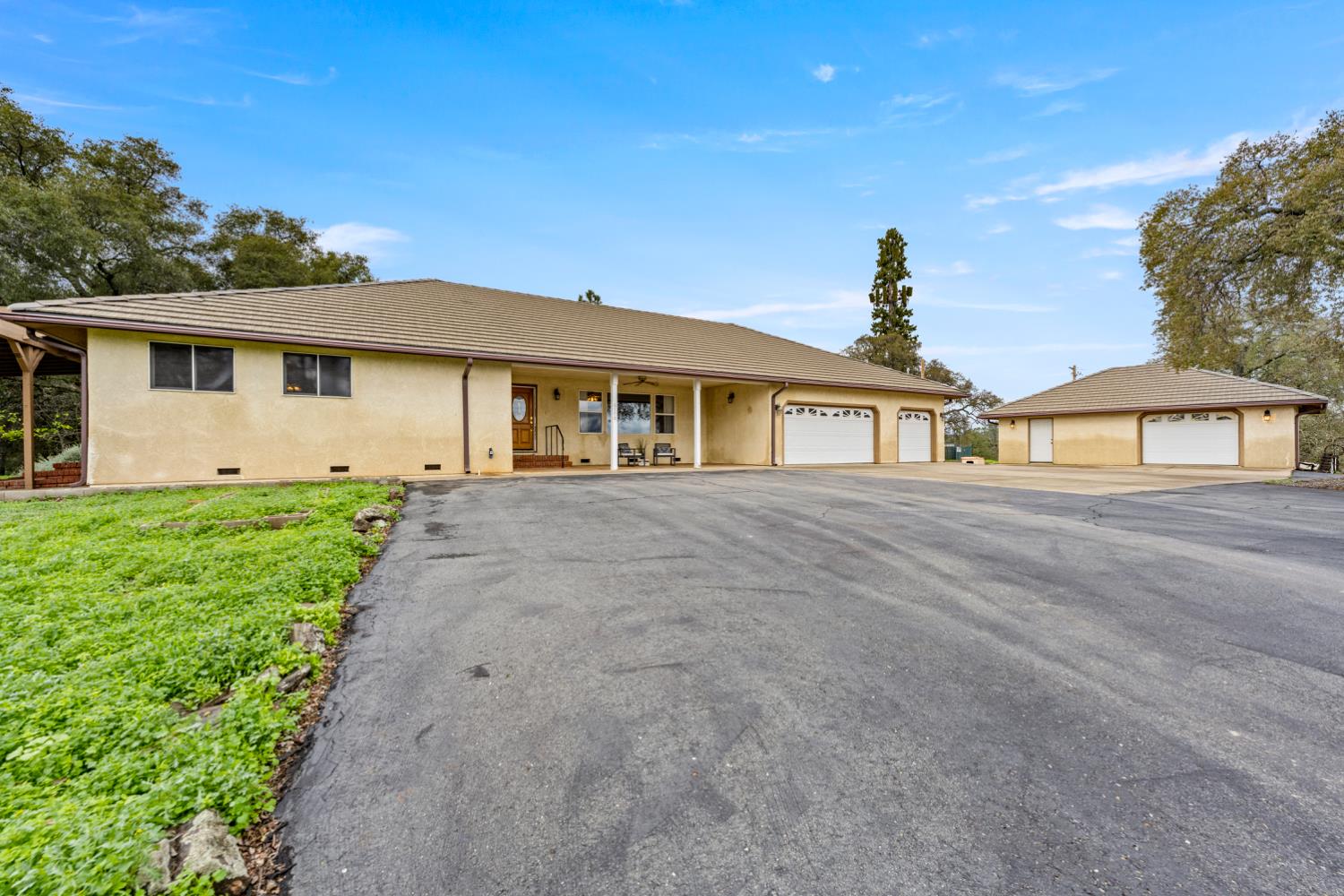 a front view of a house with a garden