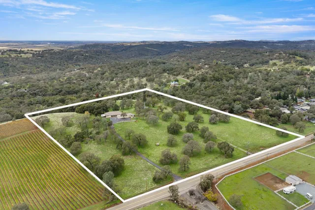 a dining room with furniture and a large window