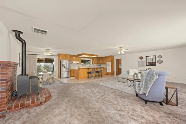 a kitchen with stainless steel appliances granite countertop a refrigerator and cabinets