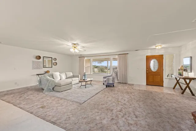 a bathroom with a granite countertop sink a toilet and shower