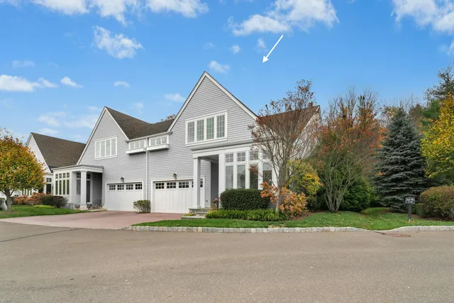 a view of a white house with a yard