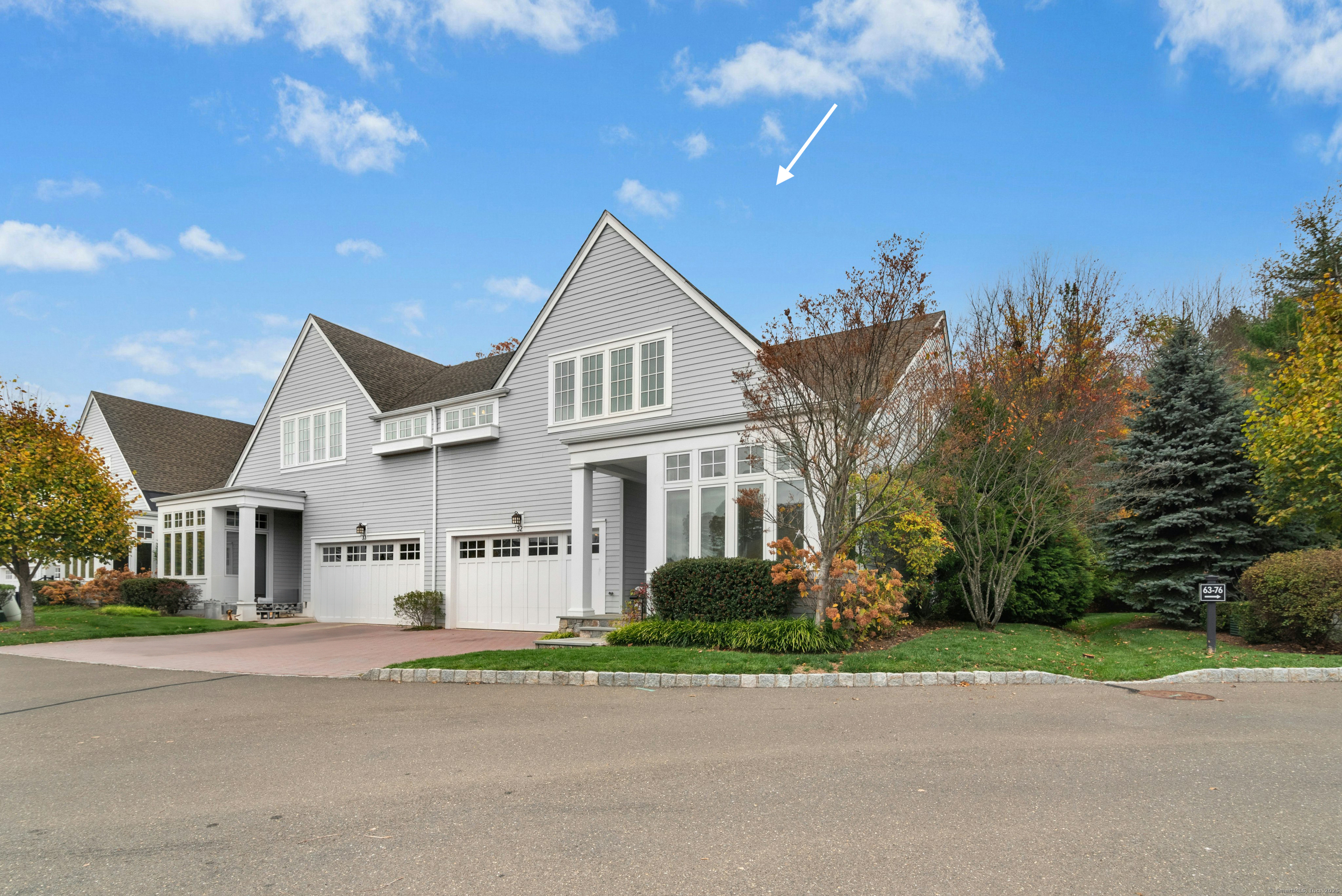a view of a white house with a yard