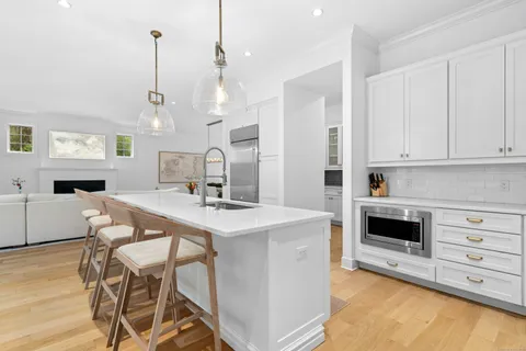 a view of kitchen with cabinets and window