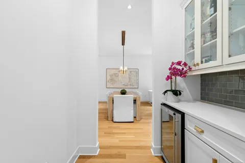 a hallway with a table and a couch