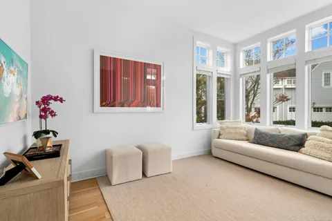 a living room with furniture and flowers
