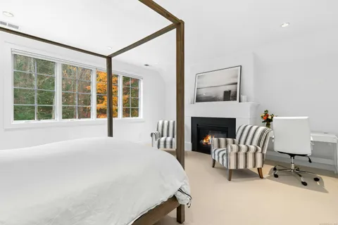 a bedroom with a bed and a fireplace