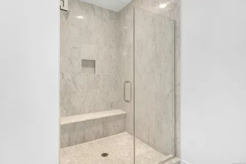 a bathroom with a glass shower door
