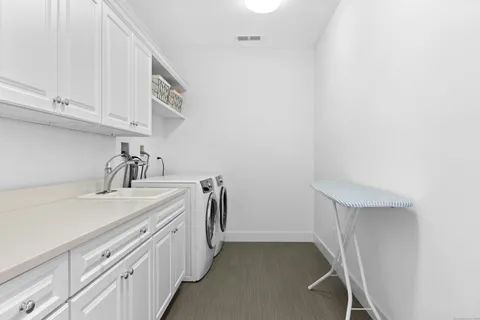 a room with a sink and cabinets
