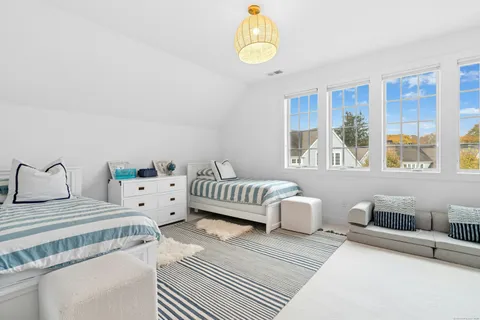 a bedroom with two beds and a large window