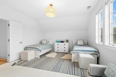 a bedroom with furniture and a window