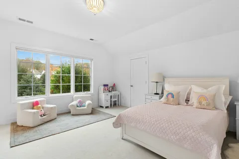 a bedroom with a bed and large window