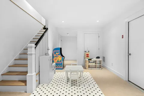 a bedroom with furniture and a book shelf